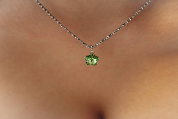 istock Beutiful silver necklace with green malachite gem. Women breast 637400470