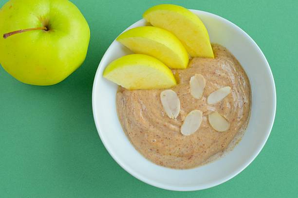 istock Almond butter yogurt with sliced apple in a bowl 637401958