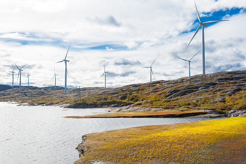 Wind turbines in a wind powered renewable energy production plant in barren landscape of north Norway