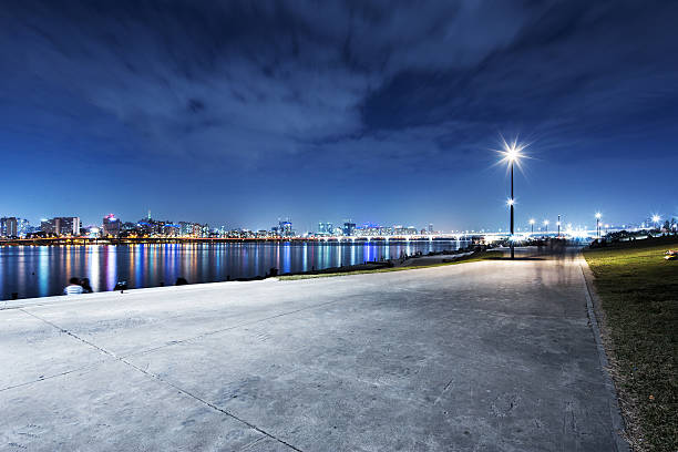 cityscape and skyline of seoul from empty brick floor at night