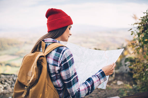istock Travel girl checking map 637407134