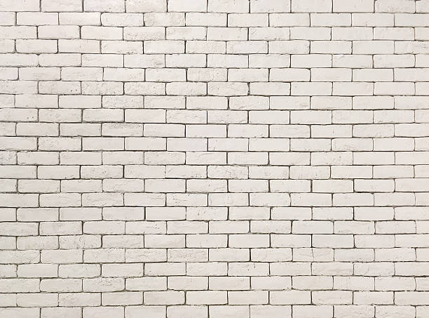 istock Closeup surface old cream color stone brick wall textured background 637407712