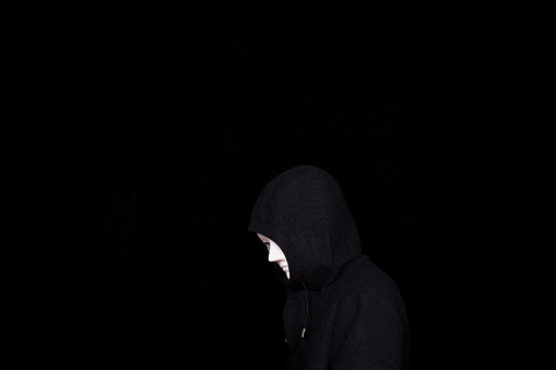 man wearing mask, in hoodies tweed coat