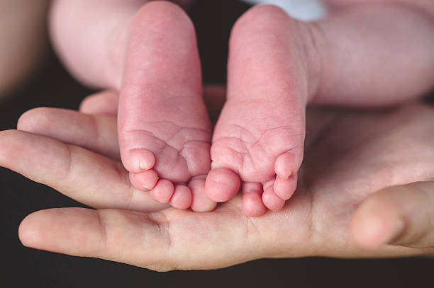 istock Baby Feet in Loving Hug 637413058
