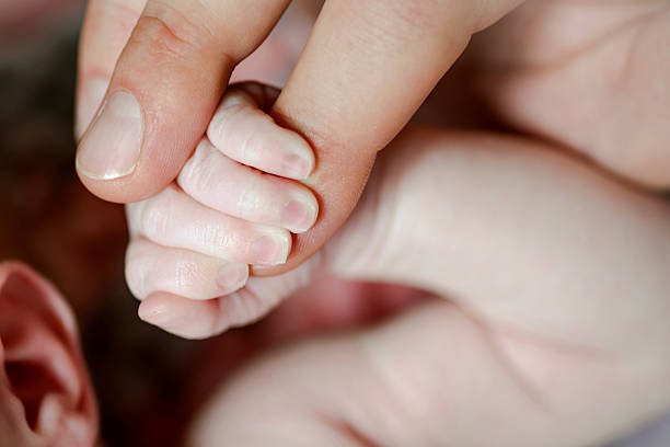 istock Baby Holding Mother`s Hand 637413260