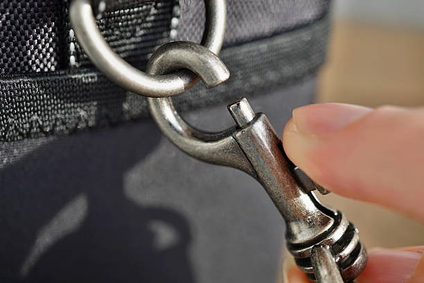 istock Releasing a snap-hook (snap-link) fastened to the black bag 637417638