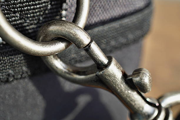 istock Releasing a snap-hook (snap-link) fastened to the black bag 637417662