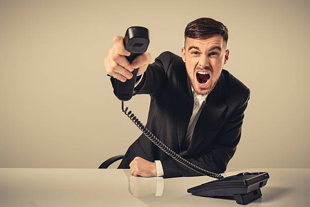 istock young man dials the phone number while sitting in the 637417710