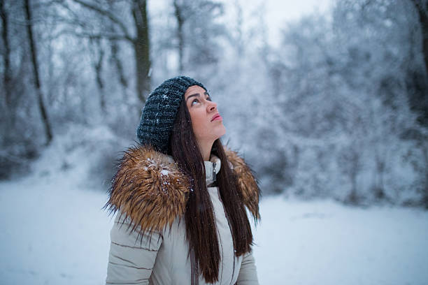 istock Woman walking on snowy landscape 637421230