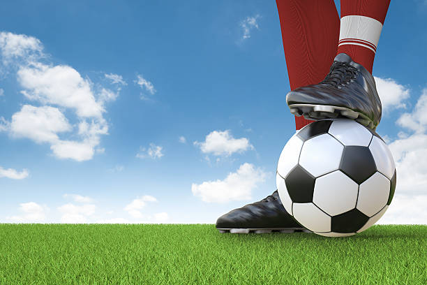istock soccer player standing with soccer ball 637421378