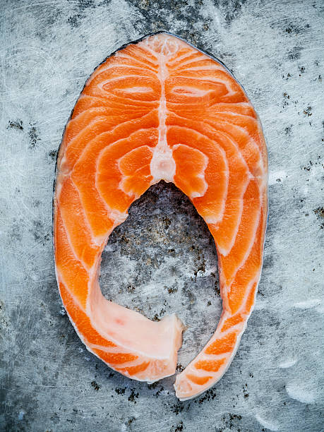 Closeup fresh salmon fillet sliced flat lay on shabby metal
