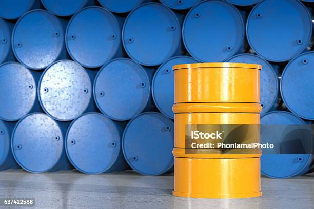 Yellow Barrel With Blue Barrels Background Stock Photo - Download Image Now - Lubrication, Drum - Container, Barrel