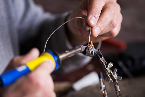 Closeup of soldering iron and tweezers