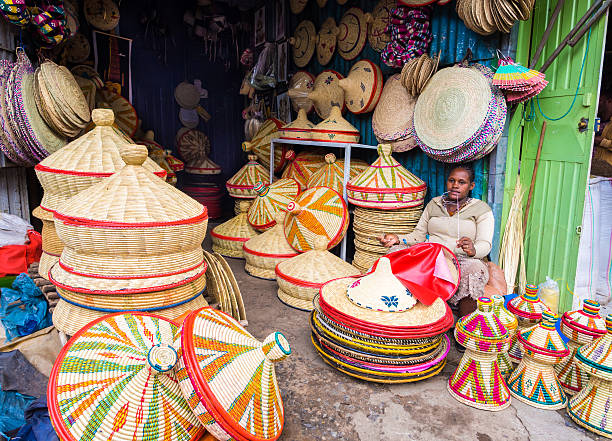 Making of Habesha baskets Addis Abeba, Ethiopia - June 6, 2016: Ethiopian woman makes Habesha baskets for sale on a local market in Addis Abeba, on the 6th of June 2016. addis ababa ethiopia photos stock pictures, royalty-free photos & images