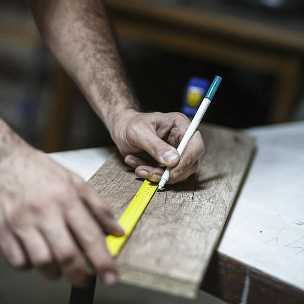 istock Drawing with construction pencil on wood and measuring tool 637443212