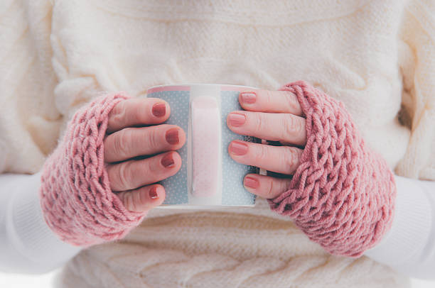 istock Hot drink in beautiful cup in hands close up 637444024