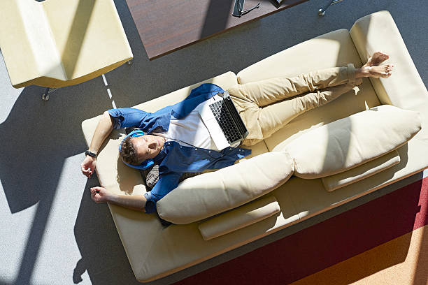 istock Man listening music while relaxing at home 637456608