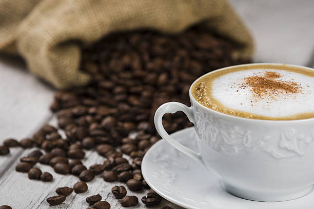 istock Cup of Cappuccino with Coffee Beans 637456888
