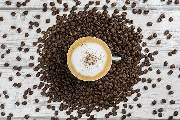 istock Coffee beans and a cup of Cappuccino 637457564