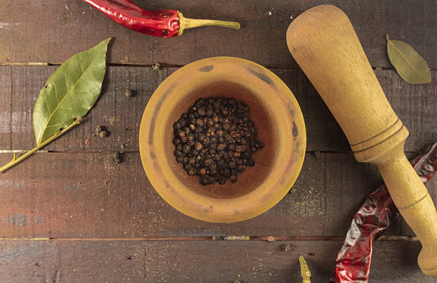 istock Mortar with peppercorns and pestle, candid photo 637457898