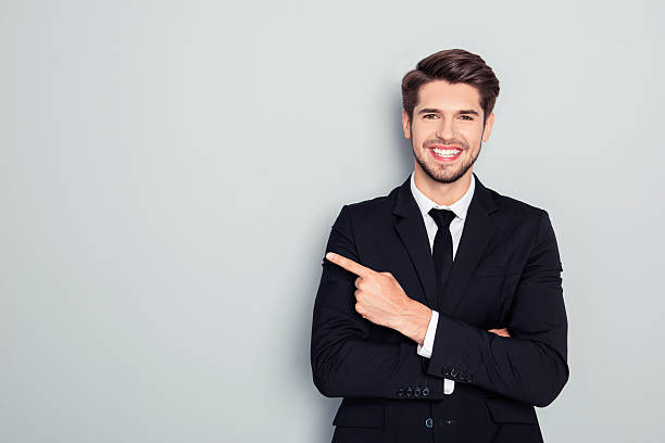 istock Young handsome businessman with beaming smile pointing with finger 637458182