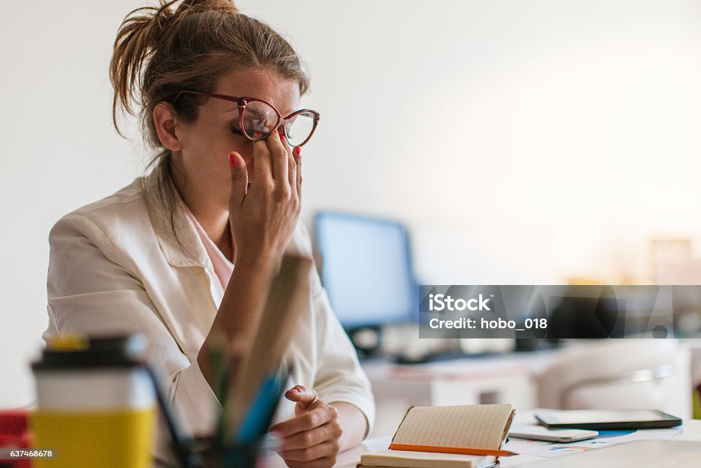 Young and beautiful businesswoman tired from work in the office Tired Stock Photo