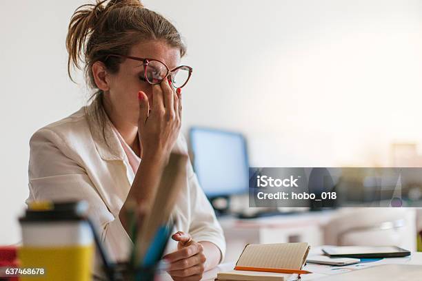 Young And Beautiful Businesswoman Tired From Work In The Office Stock Photo - Download Image Now