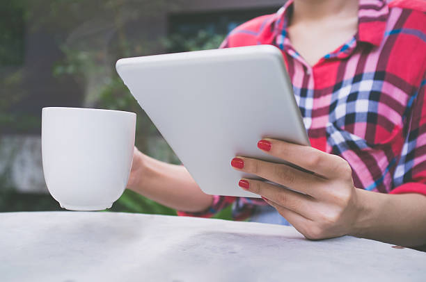 istock Young woman using tablet in coffee shop. 637469658