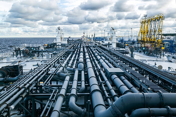 istock Oil product tanker is loading from shore terminal. 637470396