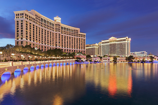 Las Vegas, USA - December 10, 2016: Night time view of the resort hotels - Bellagio and Caesars Palace - reflected in man-made lake Bellagio.