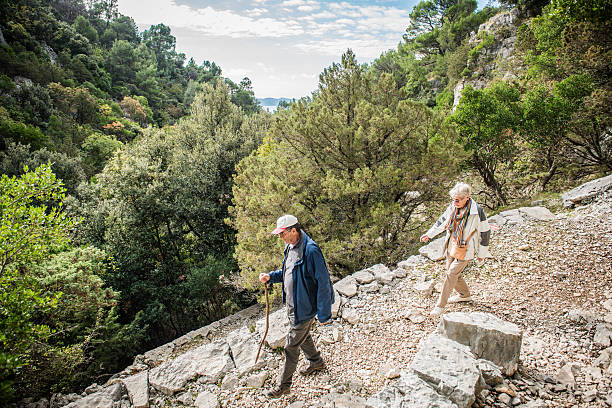 senior paar wandern in richtung pustinja blaca, brac island, kroatien, europa - tranquil scene joy vacations high angle view stock-fotos und bilder