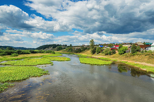 istock Summer landscape with village by the river 637481602