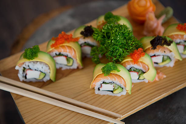 istock Beautifully decorated sushi on a plate with avocado and caviar. 637481752