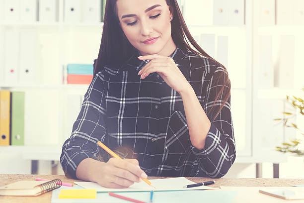 istock Serious woman is drawing with pencils 637481940