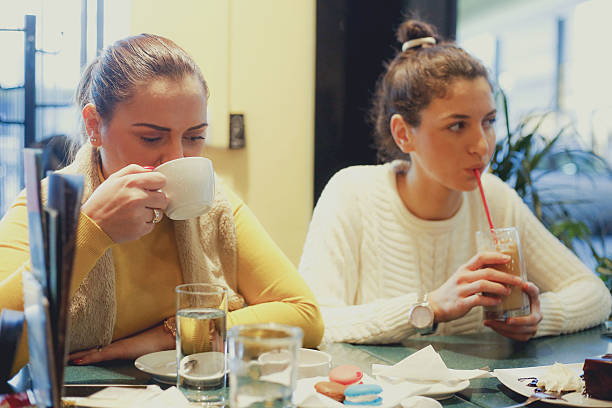 istock Two female friends drinking coffe at a coffee shop 637482458