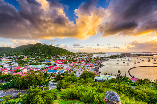 A stunning sunset in the British Virgin Islands. The sky, ablaze with vibrant shades of orange and pink, reflects on the tranquil Caribbean waters, creating a picturesque and peaceful evening scene on the sea.