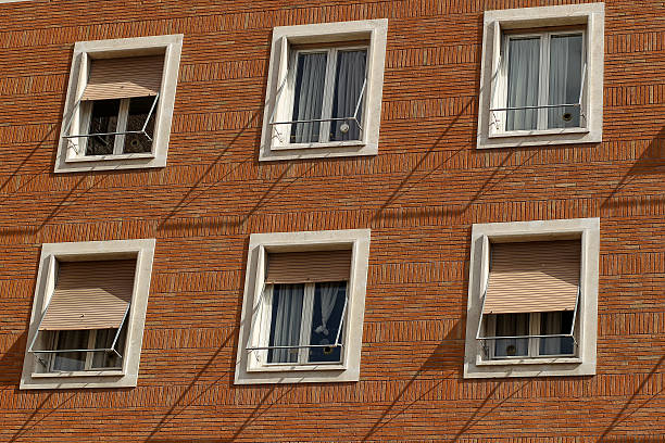 istock Building facade with windows, on blue sky, Rome, Italy 637492220