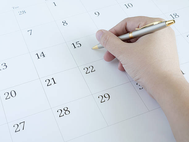 istock Woman hand writing on calendar 637493326