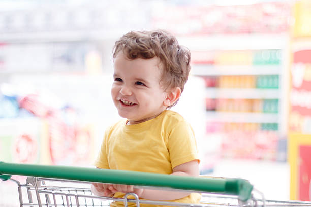 istock Boy in shopping trolley 637495452
