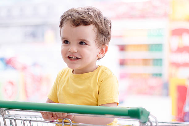 istock Liitle boy in shopping trolley 637495586
