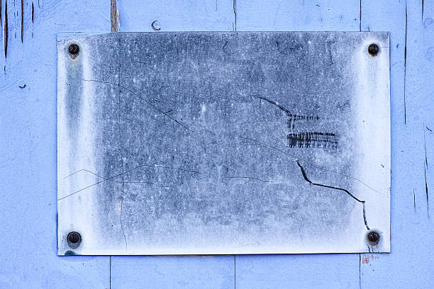 istock Weathered metal sign fixed to an old wood fence. 637500664