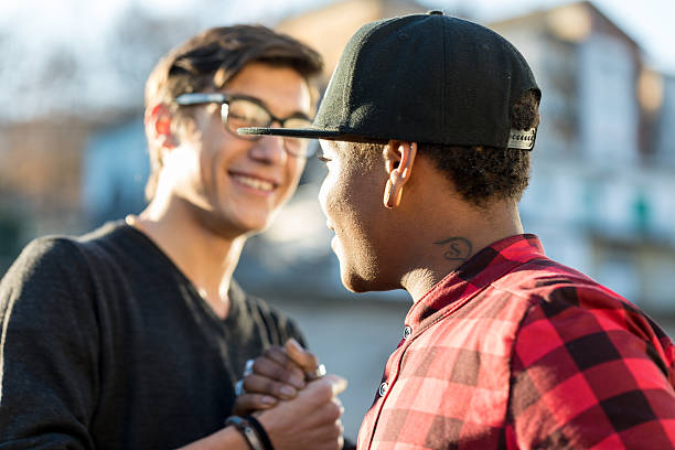 istock good friends joking about their secret handshake 637504518