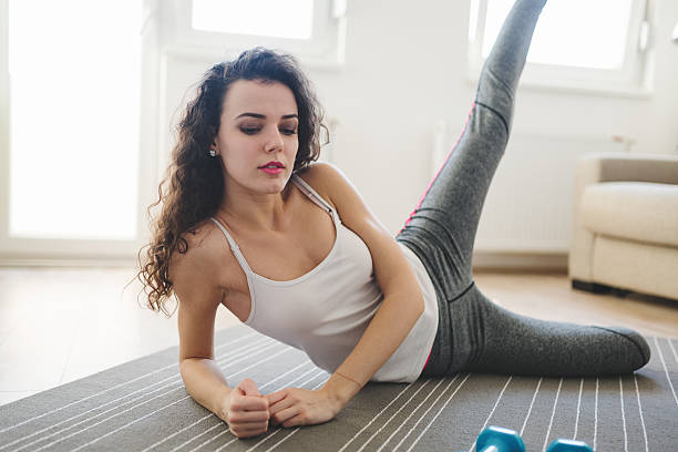 istock Fit  sportswoman exercising at home 637505018
