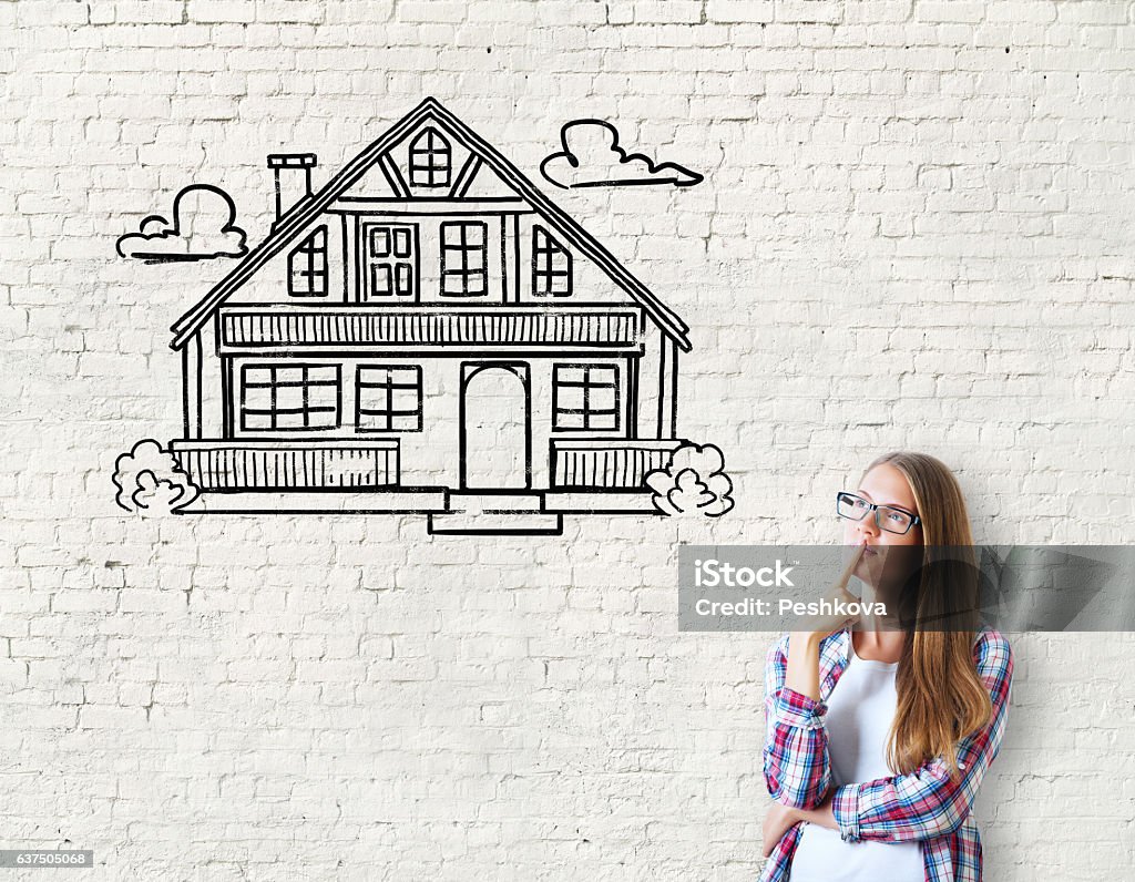 Real estate, mortgage and housing Attractive caucasian girl on brick background with house sketch. Real estate, mortgage and housing concept Day Dreaming Stock Photo