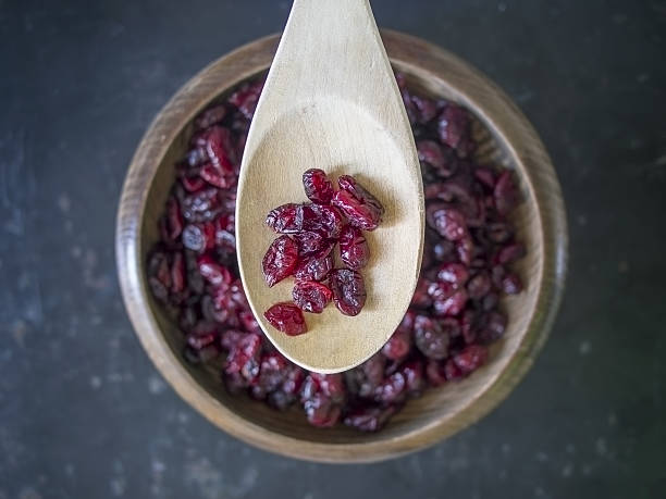 istock Dried cranberries above shot on dark background 637506974