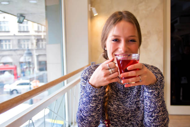 istock Young Woman Drinking Tea in a Cafe 637507656