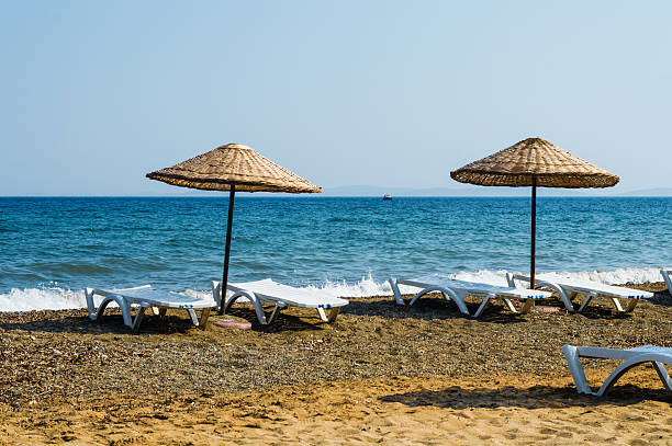 istock Straw umbrellas on empty seaside beach in Turkey 637510266