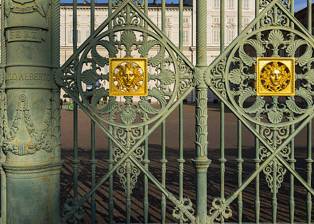 Turin, Italy - November 29, 2015: In Piazza Castello (Castle Square), detail of the iron gate (1840) separating Piazza Castello and Piazzetta Reale (Royal Square). On the column, the name of the King Charles Albert of Savoy and the motto of the House of Savoy (Fert). 