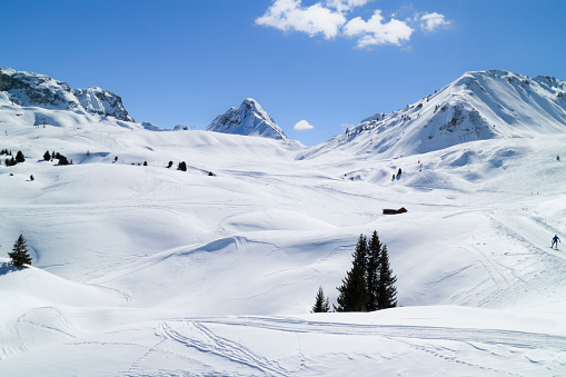 Ski snowy slopes through alpine mountains and valleys