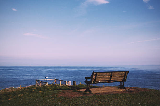 istock Empty bench over looking the coast in Bude, Cornwall Vintage 637513832